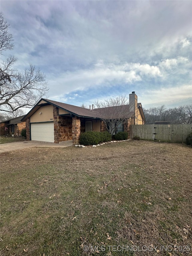 view of front of house featuring driveway, a garage, stone siding, a chimney, and fence