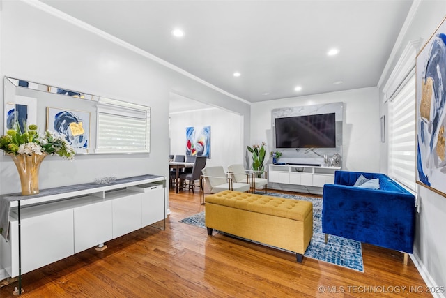 living room featuring ornamental molding, recessed lighting, and wood finished floors