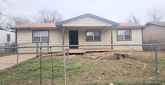 bungalow-style house with a fenced front yard and a porch