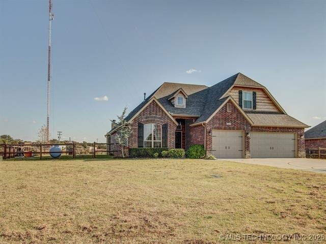 view of front of property with driveway, an attached garage, fence, a front yard, and brick siding