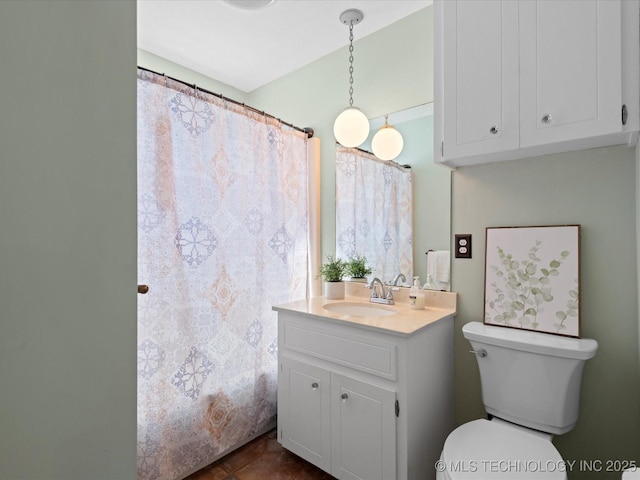 full bathroom featuring toilet, vanity, and tile patterned flooring