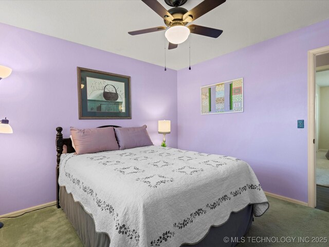 carpeted bedroom with ceiling fan and baseboards