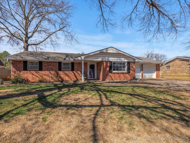 ranch-style house with driveway, brick siding, an attached garage, and a front yard