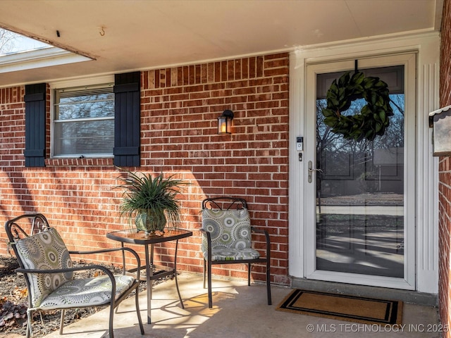 property entrance with brick siding