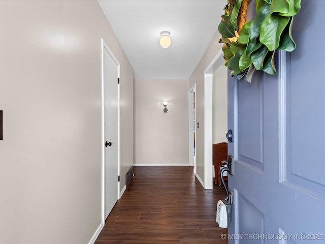 hall with wood finished floors and baseboards