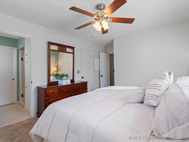 bedroom featuring light carpet and ceiling fan