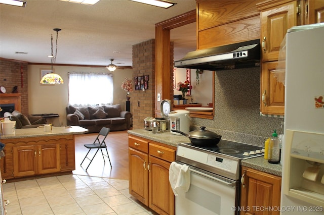 kitchen featuring under cabinet range hood, white appliances, a fireplace, open floor plan, and brown cabinets