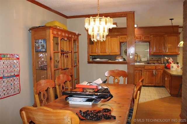 dining space featuring an inviting chandelier and crown molding