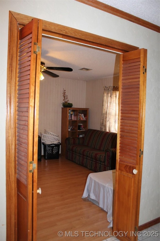 bedroom featuring a textured ceiling, wood finished floors, and crown molding