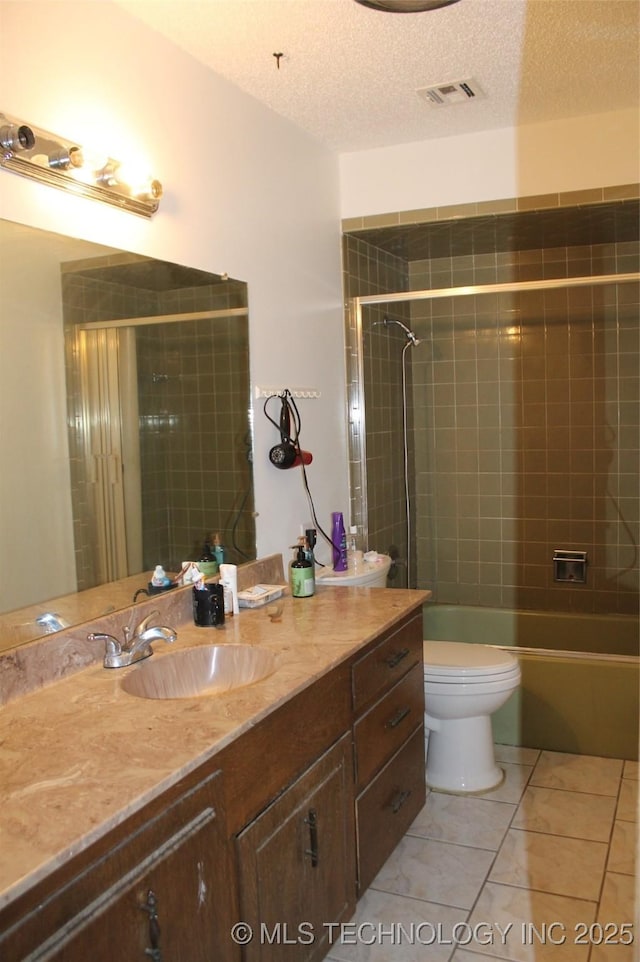 full bath featuring visible vents, toilet, a textured ceiling, vanity, and tile patterned floors