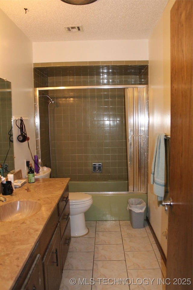 full bath featuring a textured ceiling, toilet, bathing tub / shower combination, vanity, and visible vents