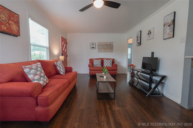living room with ornamental molding, a ceiling fan, baseboards, and wood finished floors