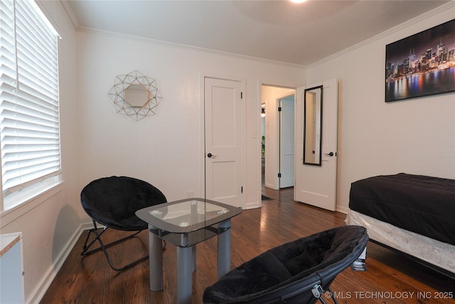 bedroom featuring ornamental molding, wood finished floors, and baseboards
