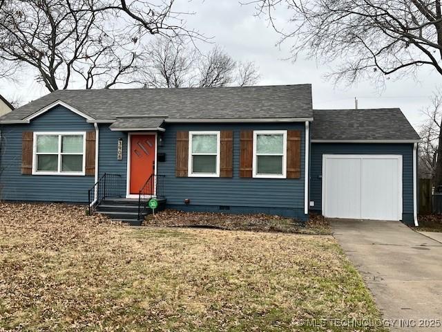 ranch-style home with crawl space, an attached garage, a front lawn, and concrete driveway