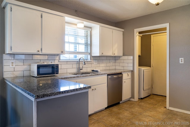 kitchen with a sink, washer / dryer, white cabinetry, and dishwasher