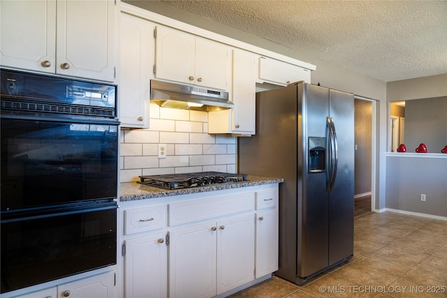 kitchen with decorative backsplash, white cabinetry, a textured ceiling, under cabinet range hood, and black appliances