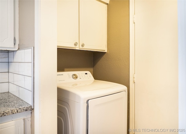 laundry room featuring washer / clothes dryer and cabinet space