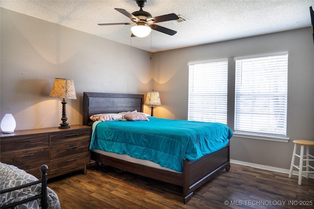 bedroom with visible vents, ceiling fan, a textured ceiling, wood finished floors, and baseboards