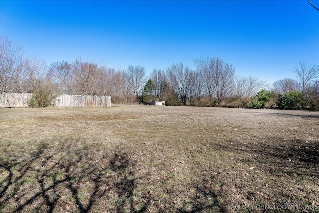 view of yard featuring a rural view and fence