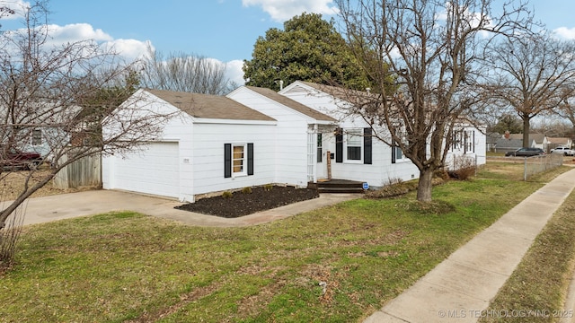 ranch-style house featuring an attached garage, fence, driveway, roof with shingles, and a front yard