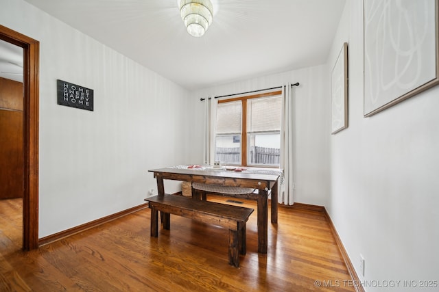 dining area featuring wood finished floors and baseboards