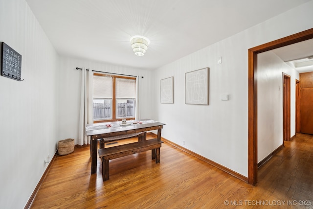 dining room with wood finished floors and baseboards