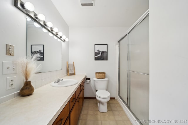 full bathroom featuring toilet, an enclosed shower, visible vents, and vanity