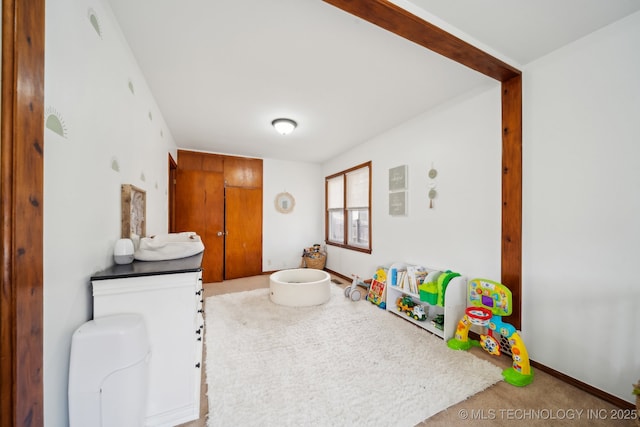 rec room featuring carpet flooring and baseboards