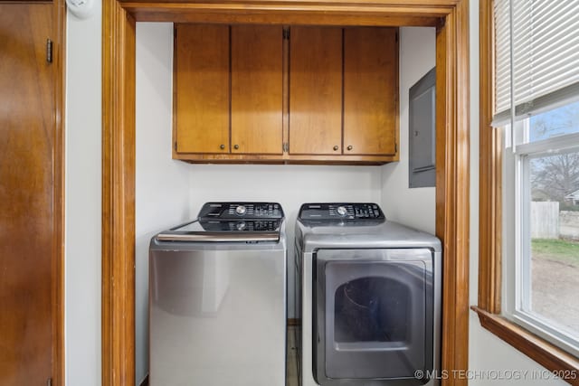 laundry area featuring washing machine and dryer and cabinet space