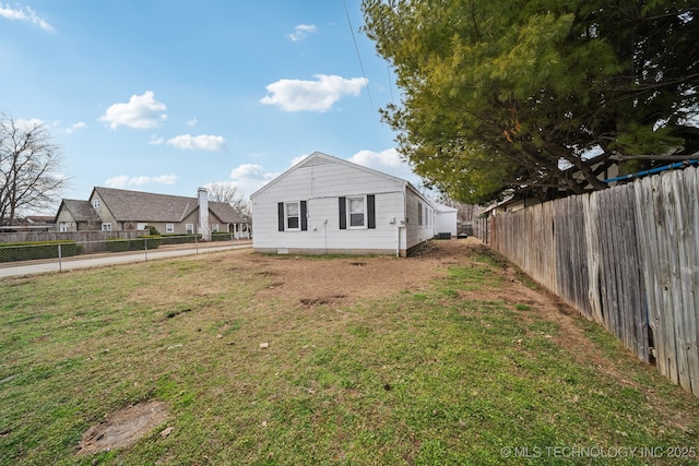 exterior space featuring a fenced backyard and a yard