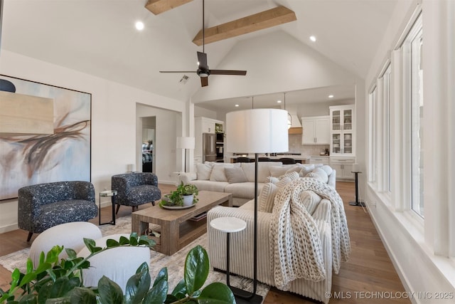 living room with high vaulted ceiling, recessed lighting, wood finished floors, baseboards, and beamed ceiling