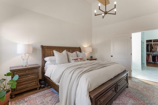 bedroom featuring a notable chandelier