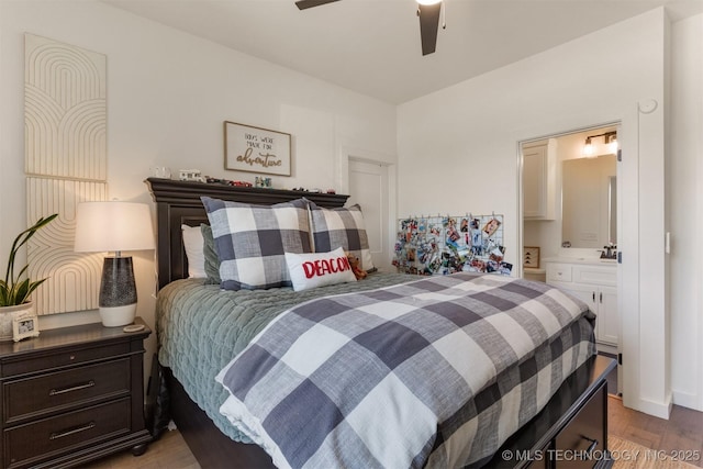 bedroom featuring light wood-style floors, a ceiling fan, and ensuite bathroom