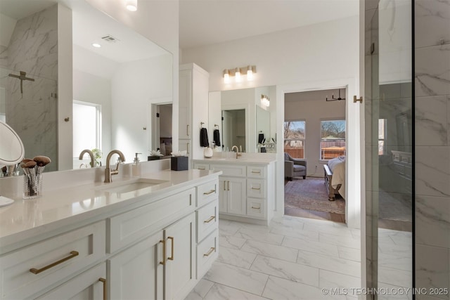 ensuite bathroom with marble finish floor, visible vents, a tile shower, vanity, and ensuite bath