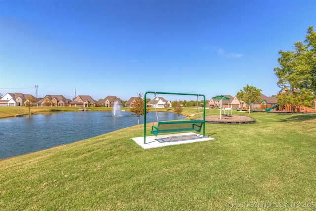 surrounding community featuring playground community, a lawn, a water view, and a residential view