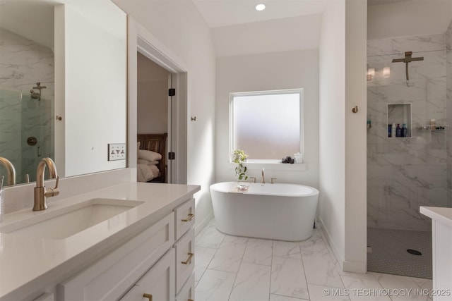 full bath featuring vanity, baseboards, a freestanding bath, marble finish floor, and a marble finish shower