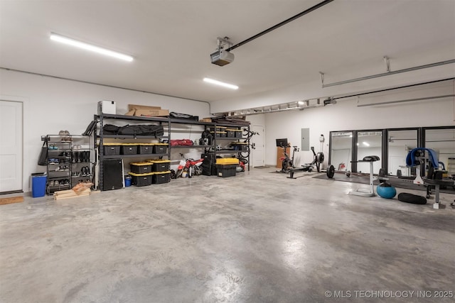 garage with a garage door opener and electric panel