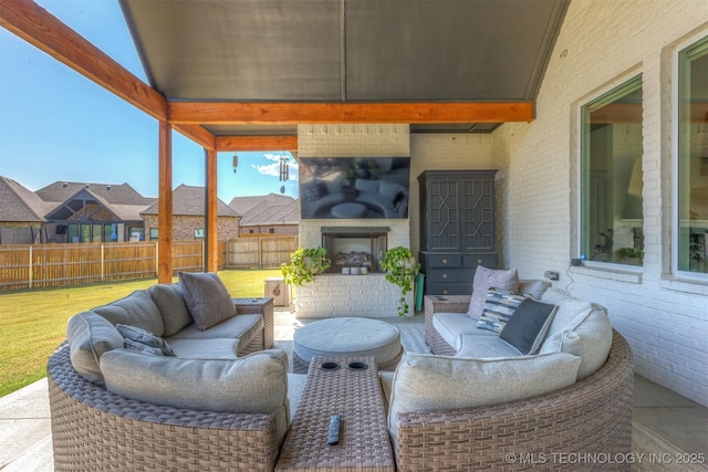 view of patio / terrace featuring an outdoor living space with a fireplace and fence