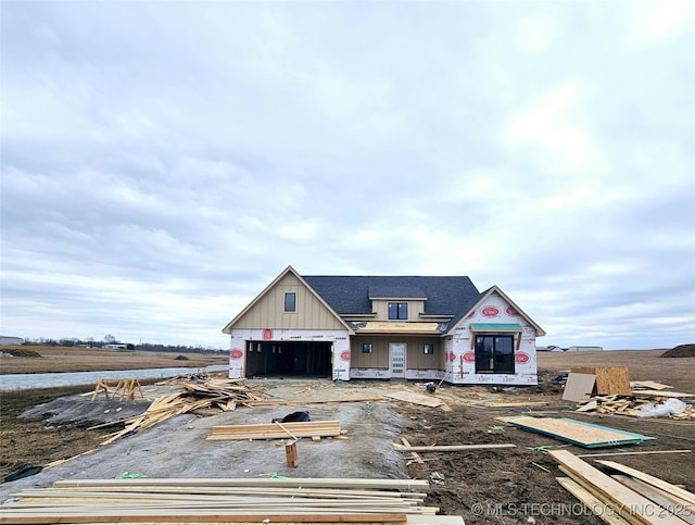 unfinished property with a garage and board and batten siding