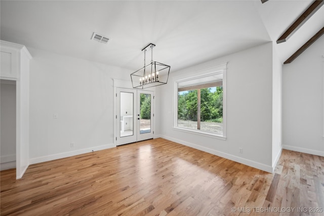 unfurnished dining area featuring light wood-type flooring, baseboards, and visible vents