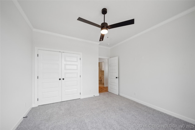 unfurnished bedroom with carpet, baseboards, and crown molding