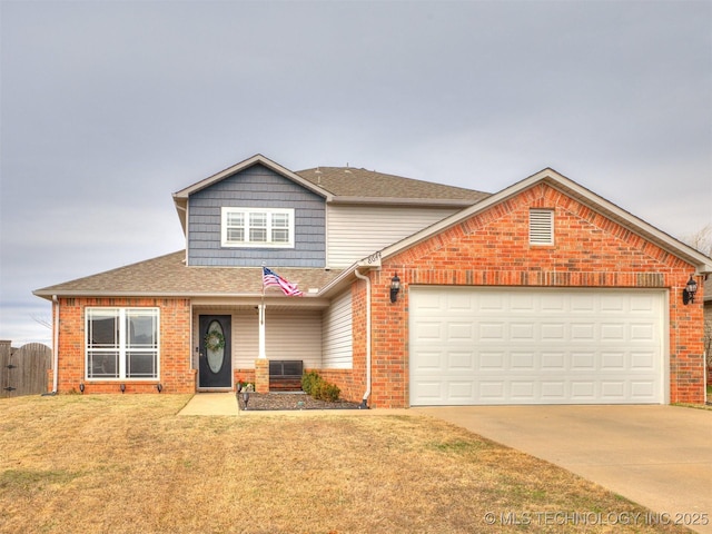 traditional home with driveway, an attached garage, a front lawn, and brick siding