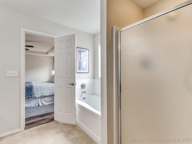 ensuite bathroom with tile patterned floors, connected bathroom, a shower stall, and a bath