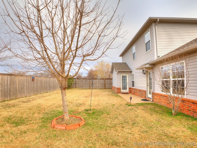 view of yard featuring a patio area and a fenced backyard