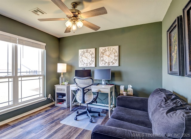 office with a ceiling fan, visible vents, and wood finished floors