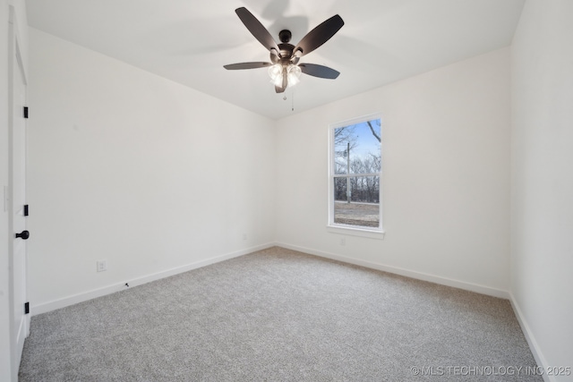 spare room with carpet flooring, a ceiling fan, and baseboards