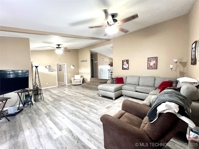 living area with vaulted ceiling, ceiling fan, wood finished floors, and baseboards