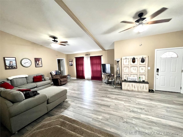 living area featuring ceiling fan, vaulted ceiling, baseboards, and wood finished floors