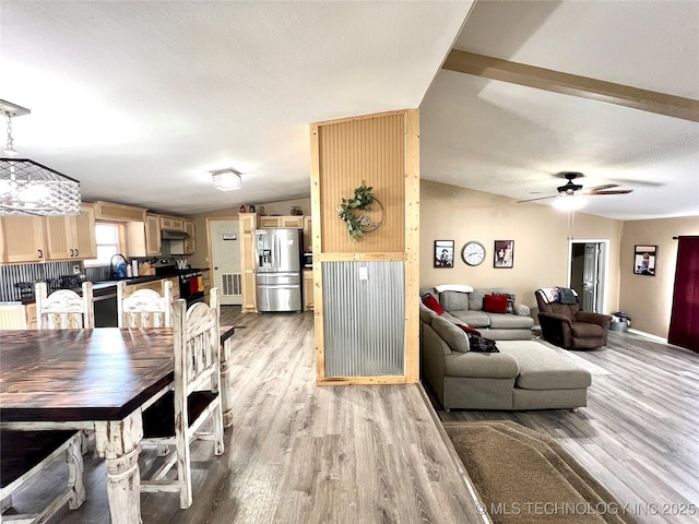 dining area with lofted ceiling, light wood-style floors, visible vents, and a textured ceiling