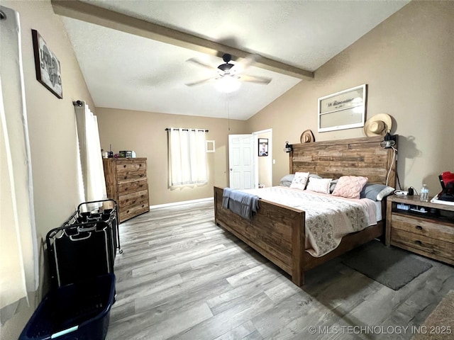 bedroom with lofted ceiling with beams, light wood finished floors, baseboards, and a ceiling fan